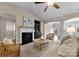 Spacious living room with a fireplace, built-in shelving, and cozy seating at 8830 Artesa Mill Ln, Charlotte, NC 28214