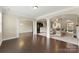 Spacious living area with hardwood floors, arched doorways, and seamless flow to other living spaces at 8830 Artesa Mill Ln, Charlotte, NC 28214