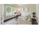 Stylish home office featuring ample natural light, neutral decor, and comfortable seating for a productive workspace at 8830 Artesa Mill Ln, Charlotte, NC 28214