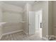 Spacious walk-in closet with ample shelving and carpet flooring, providing plenty of room for storage at 8830 Artesa Mill Ln, Charlotte, NC 28214