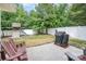 View of fenced backyard with playground, concrete patio, and grill at 8927 Comstock Ct, Locust, NC 28097