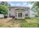 Exterior rear view features a patio, grill, and spacious backyard with a playset at 8927 Comstock Ct, Locust, NC 28097
