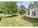 Large backyard boasts play set and a serene, tree-lined backdrop at 8927 Comstock Ct, Locust, NC 28097