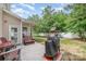 Spacious backyard features a patio, grill, playground, and lush greenery at 8927 Comstock Ct, Locust, NC 28097