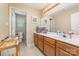Neutral bathroom featuring a double vanity and an adjacent toilet room at 8927 Comstock Ct, Locust, NC 28097
