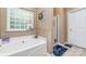 Bathroom featuring a soaking tub and a walk in shower at 8927 Comstock Ct, Locust, NC 28097