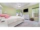 Light and airy bedroom featuring tray ceilings, carpet floors and a modern ceiling fan at 8927 Comstock Ct, Locust, NC 28097