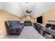 Finished bonus room with sofas, television, and ceiling fan at 8927 Comstock Ct, Locust, NC 28097