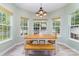 Sunlit dining area boasts large windows and a charming light fixture, perfect for enjoying meals with a view at 8927 Comstock Ct, Locust, NC 28097