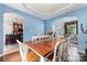 Bright dining room features hardwood floors, modern lighting, and an open floor plan to the kitchen and living room at 8927 Comstock Ct, Locust, NC 28097