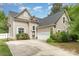 Beautiful two-story home featuring vinyl siding, manicured lawn, and a driveway at 8927 Comstock Ct, Locust, NC 28097