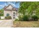 Charming home featuring a manicured lawn and a driveway leading to a two-car garage at 8927 Comstock Ct, Locust, NC 28097