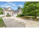 Charming two-story home featuring vinyl siding, large driveway, and beautiful landscaping at 8927 Comstock Ct, Locust, NC 28097