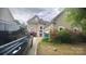Charming two-story home with vinyl siding, arched front door and blossoming azaleas at 8927 Comstock Ct, Locust, NC 28097