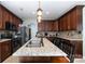 Spacious kitchen features a granite island, stainless steel appliances, and ample counter space for cooking at 8927 Comstock Ct, Locust, NC 28097