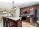 Kitchen with granite countertops, stainless steel appliances, breakfast bar, and adjacent dining area at 8927 Comstock Ct, Locust, NC 28097