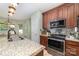 Stylish kitchen featuring a granite island, stainless steel appliances, and modern lighting fixtures at 8927 Comstock Ct, Locust, NC 28097