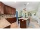 Well-appointed kitchen with a large island, granite countertops, and an eat-in dining area at 8927 Comstock Ct, Locust, NC 28097