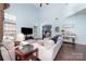 Inviting living room with soaring ceiling, plush sofas, and hardwood floors at 8927 Comstock Ct, Locust, NC 28097