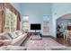 Spacious living room with soaring ceiling, hardwood floors, and open layout at 8927 Comstock Ct, Locust, NC 28097