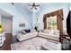 Open-concept living room with soaring ceiling, hardwood floors, and staircase at 8927 Comstock Ct, Locust, NC 28097