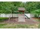 A backyard play-set sits on mulch in the shade of mature trees at 8927 Comstock Ct, Locust, NC 28097