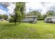 Exterior shot showcasing the house, a long green lawn, and trees at 100 Lanier St, Mount Holly, NC 28120