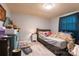 Bedroom with pale blue paneled walls, light gray vinyl flooring, and a window with a blue curtain at 100 Lanier St, Mount Holly, NC 28120