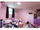 Pink bedroom with a bed, a black and white cow patterned rug, and a window with a black curtain at 100 Lanier St, Mount Holly, NC 28120