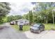 Exterior view displaying a light-colored home with a long gravel driveway at 100 Lanier St, Mount Holly, NC 28120