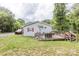 Charming exterior showing a light colored home with a wooden deck at 100 Lanier St, Mount Holly, NC 28120