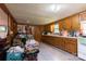 Wood paneled kitchen featuring wood cabinets, white countertops, white appliances, and light gray vinyl flooring at 100 Lanier St, Mount Holly, NC 28120