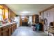 Wood paneled kitchen featuring white appliances, wood cabinets, and light gray vinyl flooring at 100 Lanier St, Mount Holly, NC 28120