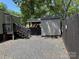 Spacious backyard featuring a wooden fence, storage shed, and direct access to the home's entrance at 102 Papoose Ct # D117, Mount Gilead, NC 27306
