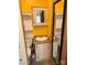 A view into a small bathroom showing the vanity, toilet, and a vibrant yellow wall at 102 Papoose Ct # D117, Mount Gilead, NC 27306