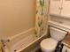 Close-up of a bathtub and toilet in a bathroom, showing fixtures and a patterned shower curtain at 102 Papoose Ct # D117, Mount Gilead, NC 27306