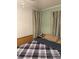 Cozy bedroom with striped curtains and a comfortable-looking bed with a checkered comforter at 102 Papoose Ct # D117, Mount Gilead, NC 27306