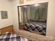 View of the bedroom with a mirrored closet showcasing the bed, offering space and style at 102 Papoose Ct # D117, Mount Gilead, NC 27306