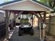 Golf cart parked under shelter, providing convenient and protected parking at 102 Papoose Ct # D117, Mount Gilead, NC 27306