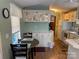 Charming eat-in kitchen featuring white cabinetry, a round table, and hardwood floors, providing a functional space at 102 Papoose Ct # D117, Mount Gilead, NC 27306