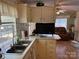 Open layout with an eat-in kitchen, showcasing light cabinetry and view into the adjoining living room at 102 Papoose Ct # D117, Mount Gilead, NC 27306