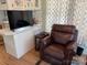 Cozy living room showing a leather recliner and TV, ideal for relaxing and entertaining at 102 Papoose Ct # D117, Mount Gilead, NC 27306