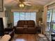 Comfortable living room showcasing a plush sofa, fan, and natural light, perfect for relaxation at 102 Papoose Ct # D117, Mount Gilead, NC 27306