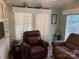 Inviting living area with classic decor, including a leather recliner and patterned curtains, creating a cozy ambiance at 102 Papoose Ct # D117, Mount Gilead, NC 27306