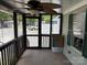 Comfortable screened porch with tiled floor, furniture, and a ceiling fan, creating a relaxing outdoor space at 102 Papoose Ct # D117, Mount Gilead, NC 27306