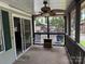 Relaxing screened porch with comfortable seating and a ceiling fan, perfect for outdoor living at 102 Papoose Ct # D117, Mount Gilead, NC 27306