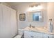 Bathroom with marble countertop, stylish mirror, and a shower with a white curtain, creating a clean and modern space at 115 E Park Ave # 428, Charlotte, NC 28203