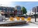 Attractive building with outdoor lounge area and vibrant yellow seating at 115 E Park Ave # 428, Charlotte, NC 28203