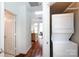 Hallway view with laundry machines and entrance to living area with hardwood floors, showing the home's layout and amenities at 115 E Park Ave # 428, Charlotte, NC 28203