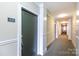Apartment hallway showing unit 428, with neutral colors and a well-maintained carpet, providing a welcoming entry at 115 E Park Ave # 428, Charlotte, NC 28203
